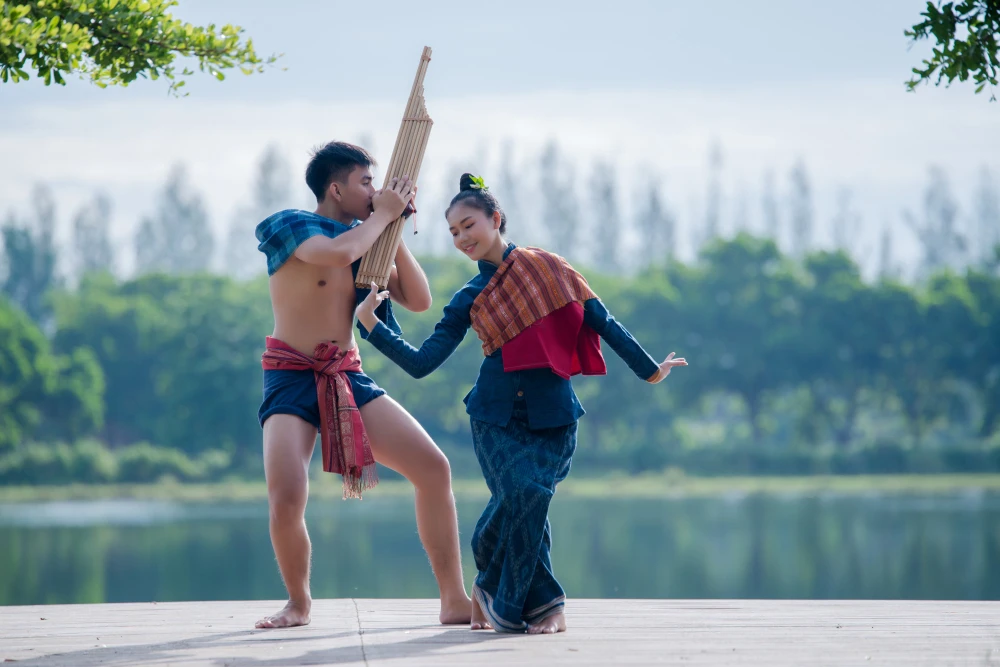 Activity - asian thailand playing flute together near to the river of country Thailand